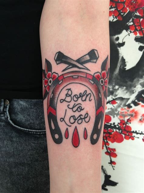 The phrase is "Born to Lose, Live to Win". . Born to lose tattoo cincinnati